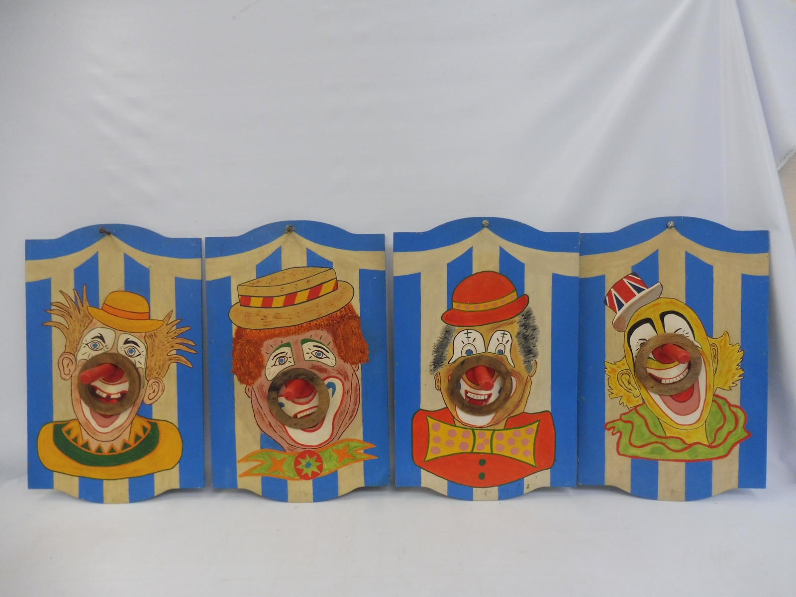 Four fairground clown hoopla boards, original artwork.