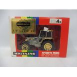 A boxed Britains no. 9892 limited edition Centenary tractor, in gold and silver livery.
