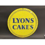 A Lyons Cakes circular double sided tin advertising sign of bright colour, 17" diameter.