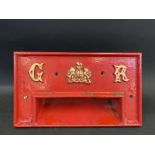 A reproduction cast iron letter box front, marked GR.