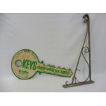 An American double sided tin advertising sign in the form of an oversized key on hanging bracket,