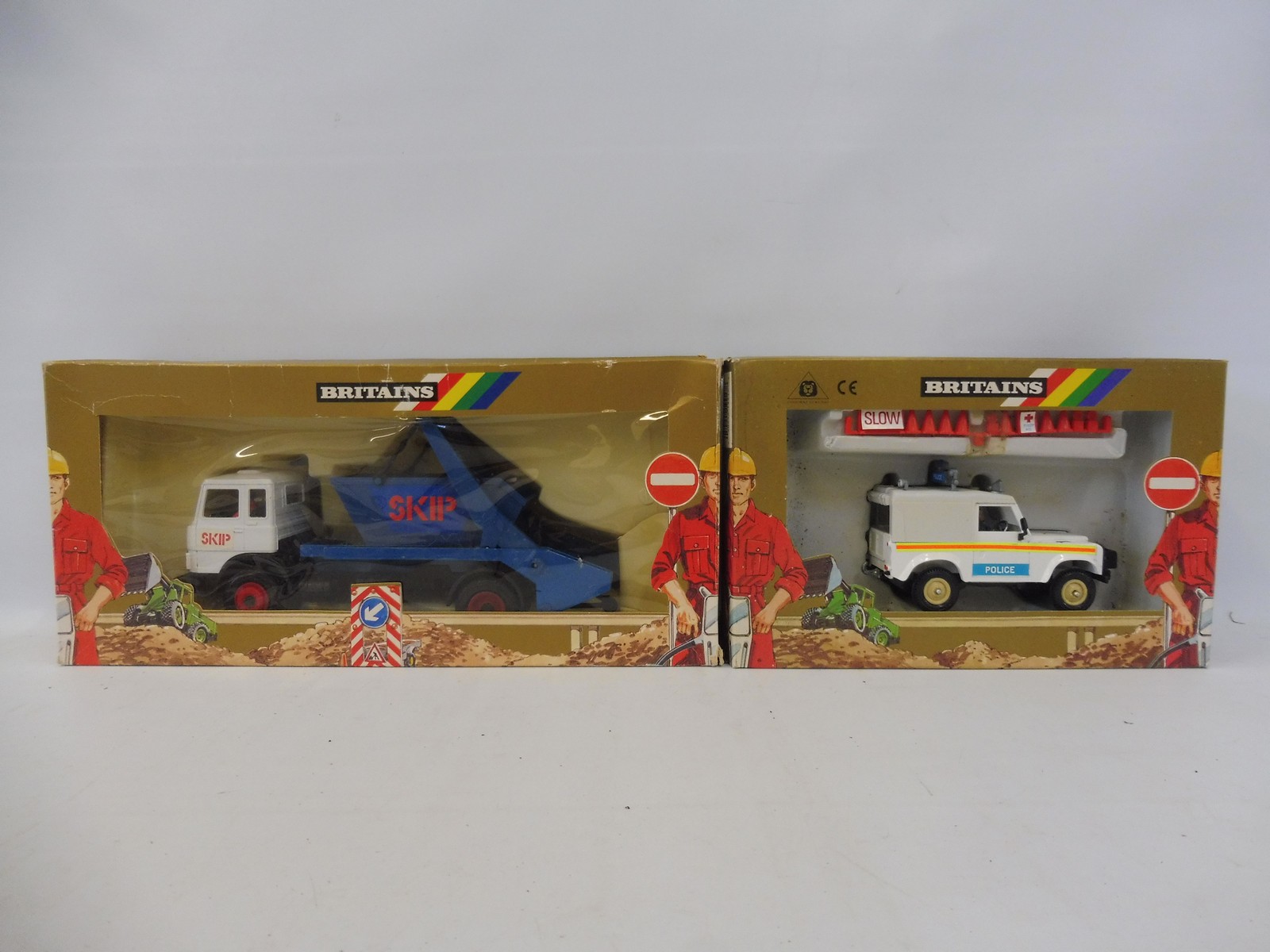 Two boxed Britains - a skip lorry and a police Land Rover no. 9177.
