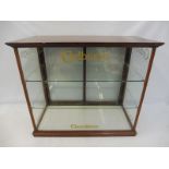 A Cadbury's Chocolates mahogany framed counter top rear opening dispensing cabinet, with etched
