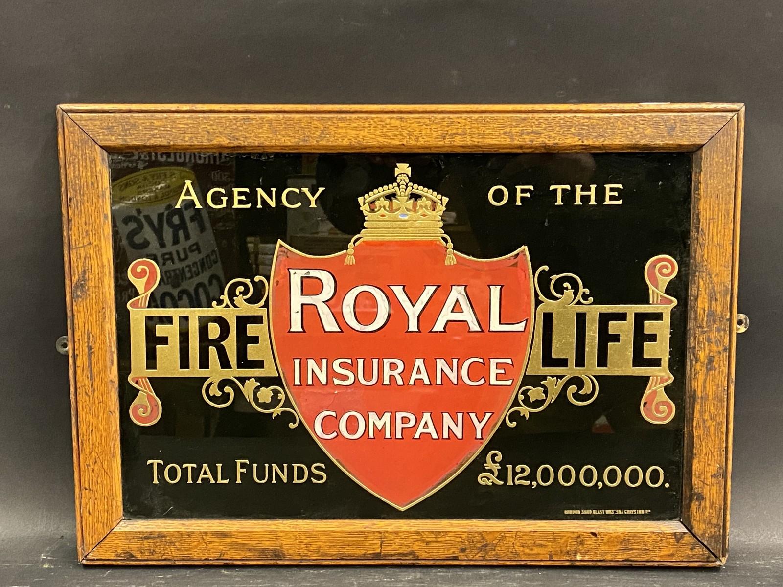 A Royal Insurance Company glass advertising sign, in an oak frame, 17 x 12".