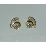 A pair of diamond stud Earrings, the central facetted diamond with a half leaf above set with four