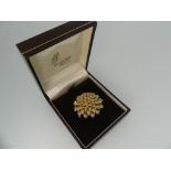 An 18ct tri-colour gold Brooch, in the form of a chrysanthemum flowerhead, formed of rose white