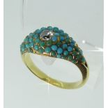A small 19thC Ring, the flared front pave set with turquoise and central diamond, all mounted in