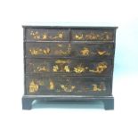 A George III japanned Chest of Drawers, with figures, animals and plants in gilt on a black