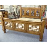 A Gothic style oak super King-size Bedstead, by Bryn Hall Furniture, the head and base boards each