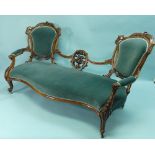 An early Victorian walnut framed Sofa, with two rounded ends and serpentine seat, the low back