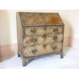 A Georgian walnut Bureau, with boxwood stringing and a fitted interior, raised on bracket feet.