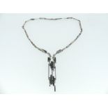 An attractive architectural style silver Necklace, formed of long interlocking bars, set with five