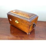 A Regency rosewood sarcophagus shaped Tea Caddy, with brass stringing and escutcheon, and fitted