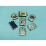 A collection of seven silver plated Vesta Cases; one 'Scottish Market' inset with agate, another '