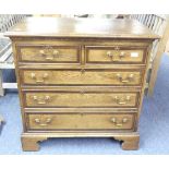 An 18thC style oak Chests of Drawers, with two short and three long cross-banded drawers, brass