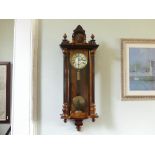 An Edwardian walnut Vienna Regulator Wall Clock, with arched top and mask relief decoration, glass