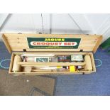 A modern Jaques Croquet Set, complete with brass bound colour coded mallets and set of four balls,