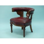A late Victorian oak Desk Chair, the horseshoe-shaped back with carved show frame, upholstered in