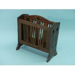 Liberty & Co.; an Arts & Crafts oak magazine rack, with angled slatted sides, the ends pierced