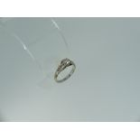 A solitaire diamond Ring, the facetted diamond c.0.4ct, the shaped shoulders each set with two small