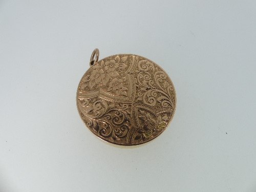 A circular 9ct gold Hinged Locket, the front and reverse engraved with scrolling foliate decoration, - Image 2 of 2