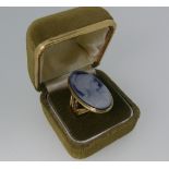 An oval hardstone Cameo Ring, the 9ct yellow gold shank with split shoulders, Size R.