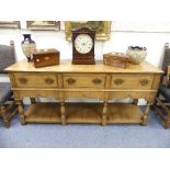 A 17thC style oak open Dresser, by Bryn Hall Furniture, with three frieze drawers above shaped apron