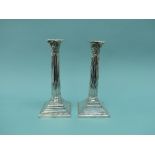 A pair of Edwardian silver Corinthian Column Candlesticks, by Barker Brothers, hallmarked Chester,