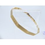 A 9ct gold Salve Bangle, with alternate sections of engine turned decoration and Greek Key design,