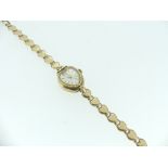A 9ct gold Everite lady's Wristwatch, the silvered heart-shaped dial with gilt baton markers, on a