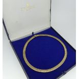 A 9ct yellow gold flexible link Necklace, the textured links with ropework borders, marked on the