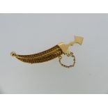 A 22ct yellow gold Dagger with Scabbard Brooch, with filigree decoration, unmarked but tested,