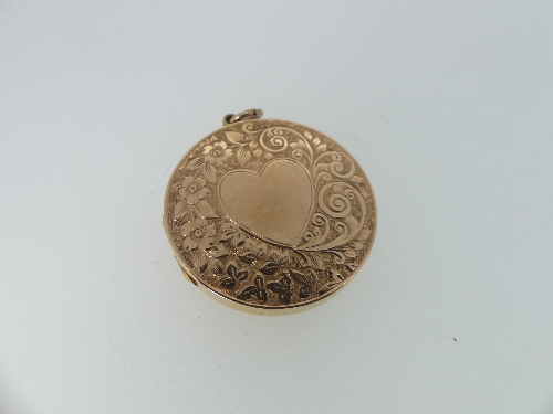 A circular 9ct gold Hinged Locket, the front and reverse engraved with scrolling foliate decoration,