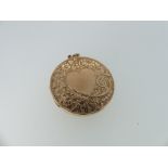 A circular 9ct gold Hinged Locket, the front and reverse engraved with scrolling foliate decoration,