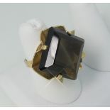 A 9ct yellow gold Dress Ring, the front set diagonally with a large square smokey quartz within a
