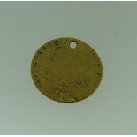 A George III gold Guinea, dated 1775, coin worn and drilled with hole above monarch's head.