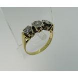 A three stone diamond Ring, the graduated stones individually mounted in white metal, the centre