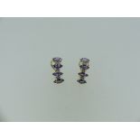 A pair of 14k gold tanzanite and diamond Earrings, formed of four marquise tanzanites with two small