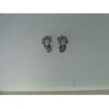 A pair of opal and diamond Ear Clips, the oval opal mounted above six millegrain set graduated