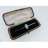 An 18ct yellow gold and platinum Bar Brooch, the centre set with an oval opal, the stone 20mm