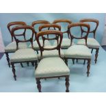 A set of eight Victorian mahogany Balloon Back chairs, with stuff-over seats on ring turned legs,