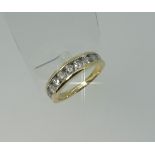 A 9ct yellow gold channel set diamond Ring, mounted with ten graduated diamonds, Size P.