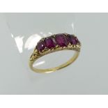 A graduated five stone ruby Ring, each ruby with a diamond point above and below, two missing and