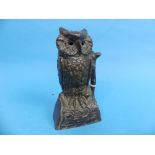 A late 19thC American cast iron Novelty Money Box, in the form of an owl with revolving head