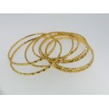 A collection of eight 22ct yellow gold Slave Bangles, all unmarked but tested, approx total weight