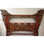 A 19th century Chinese red lacquered bed Headboard / Screen, Qing dynastry, with carved, painted and