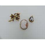 A 9ct yellow gold Spray Brooch, formed of three flower heads and buds set with mauve pastes,