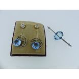 A pair of synthetic blue stone Earrings, the facetted blue stone in pierced fan shaped 9ct white