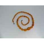 An Amber bead Necklace, formed of forty seven graduating beads, largest bead 23mm long, total length