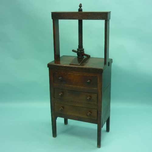 A George III oak Book Press on Chest of Drawers, the rectangular press with turned thread and